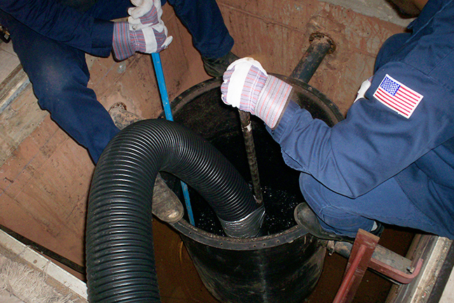 two men working on an Acid Neutralization Tank